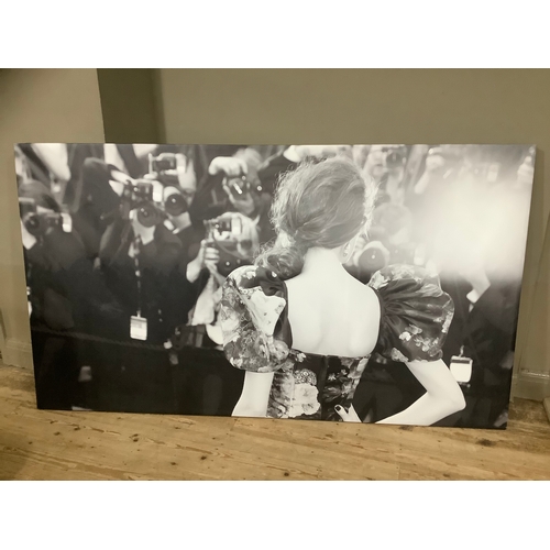 127 - A black and white print on canvas of a woman at a premiere in a floral dress in front of press, 130c... 