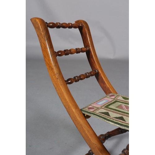 149 - A VICTORIAN CHILD'S ROSEWOOD FOLDING CHAIR WITH TRIPLE SPINDLE BAR BACK, slung needlework seat, on t... 