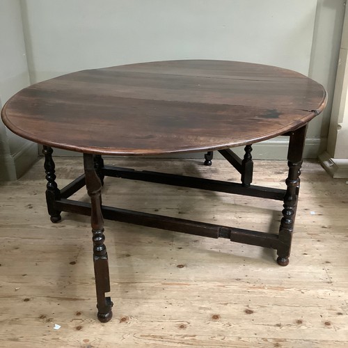 183 - A 19th century oak drop leaf dining table on baluster turned legs and square framing, 136cm long