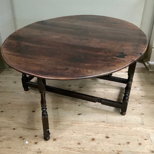 183 - A 19th century oak drop leaf dining table on baluster turned legs and square framing, 136cm long