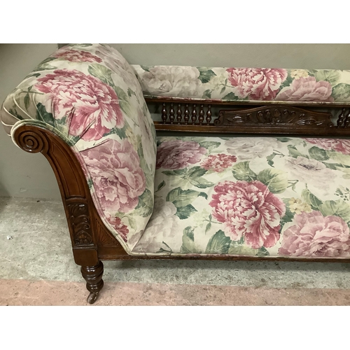 456 - A late Victorian stained beech chaise lounge with spindle back, upholstered in printed floral Heming... 