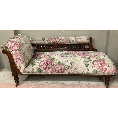 456 - A late Victorian stained beech chaise lounge with spindle back, upholstered in printed floral Heming... 