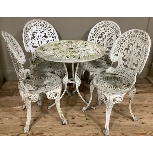 160 - A set of cast iron white garden chairs and table, ornate with pierced decoration