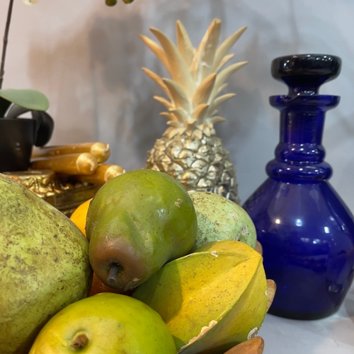 234 - A resin pineapple, two faux orchids, a gilt jardinière stand, wooden fruit bowl with faux fruits, gi... 