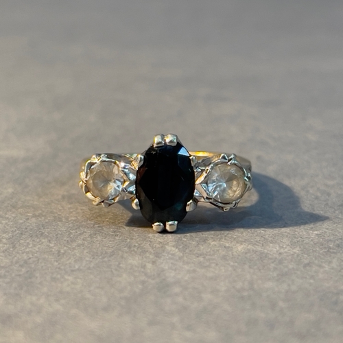 388 - A three stone ring circa 1950 in 18ct. yellow gold and platinum set with an oval facetted sapphire a... 