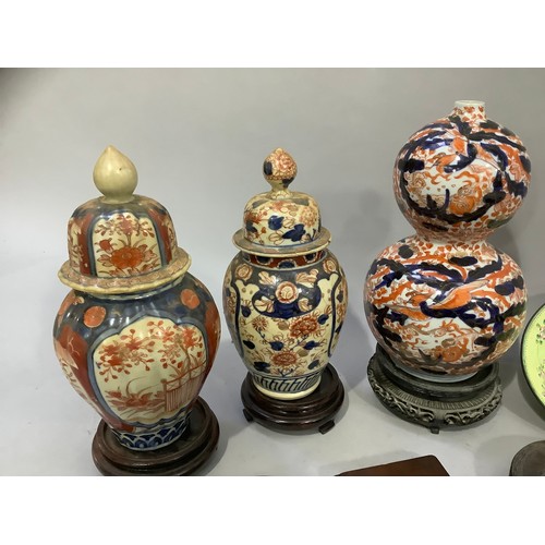 197 - Two late 19th century Imari vases and domed covers, 25cm and 24cm, two cloisonné vases and two dishe... 