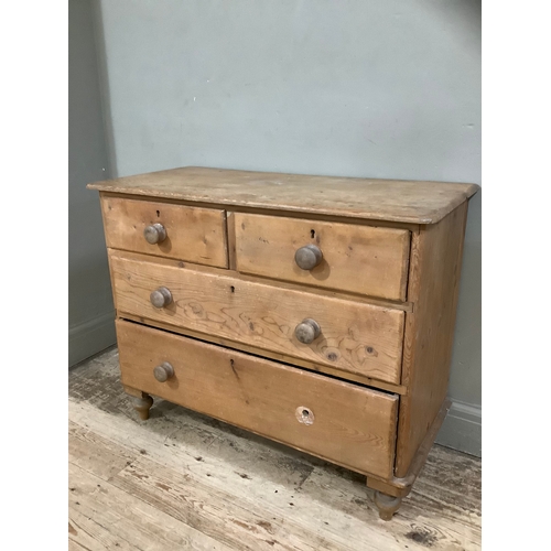 139B - A pine chest of two short above three long drawers on bun feet