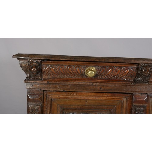 425 - A 19TH CENTURY CONTINENTAL OAK CUPBOARD, having a moulded and writhen lobe carved cornice fitted wit... 