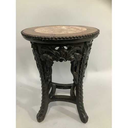 404 - A carved Chinese hardwood jardiniere, the top inset with marble, 47cm high