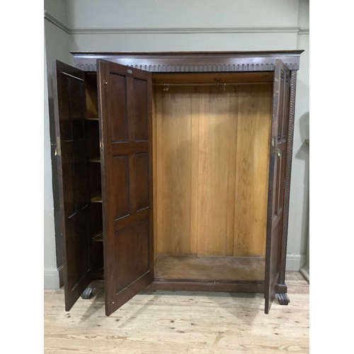 406 - An early 20th century oak bedroom suite by Waring and Gillow of Lancaster comprising triple wardrobe... 