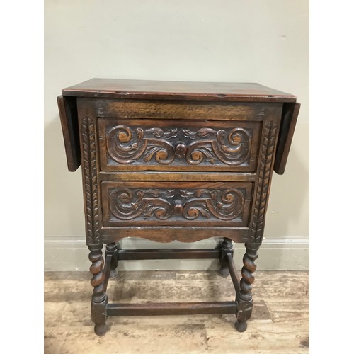 407 - An early 20th century oak drop leaf two drawer side table on barley twist legs having heavily carved... 