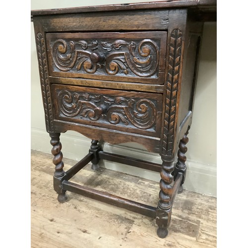 407 - An early 20th century oak drop leaf two drawer side table on barley twist legs having heavily carved... 