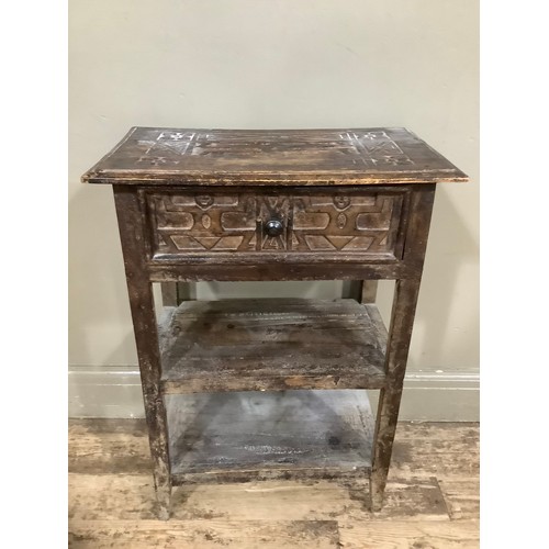 414 - A fruitwood side table with one drawer above two tiers and having indigenous style carvings, 55cm wi... 