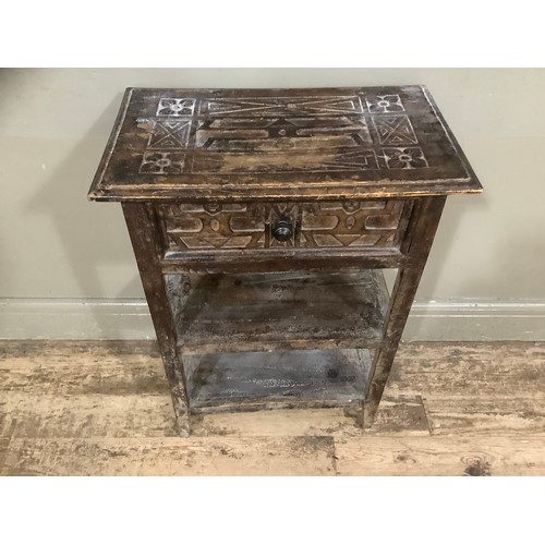 414 - A fruitwood side table with one drawer above two tiers and having indigenous style carvings, 55cm wi... 