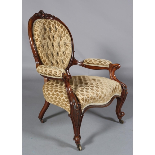 436 - A VICTORIAN MAHOGANY ARMCHAIR having an encircling frame with foliate and harebell cresting, buttone... 