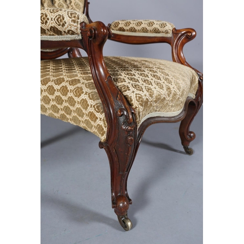 436 - A VICTORIAN MAHOGANY ARMCHAIR having an encircling frame with foliate and harebell cresting, buttone... 