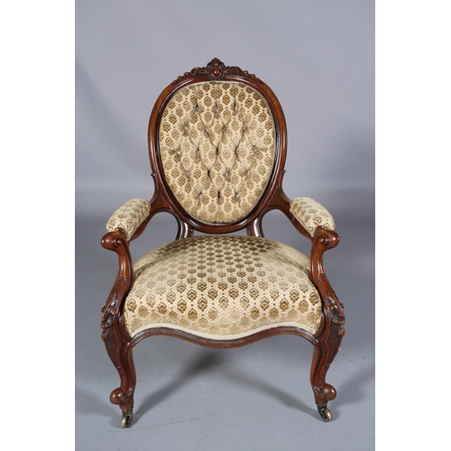 436 - A VICTORIAN MAHOGANY ARMCHAIR having an encircling frame with foliate and harebell cresting, buttone... 