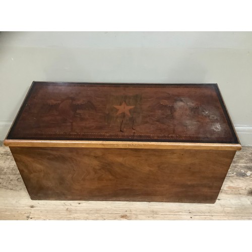 421 - A mahogany chest with hinged lid inlaid with colonial scene depicting two sea birds surmounting shie... 