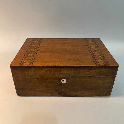 215 - A 19th century walnut writing slope the lid inlaid having a mother of pearl escutcheon, with a fitte... 