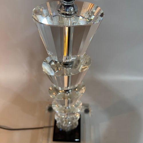 263 - A clear glass and chrome standard lamp of ten facetted knops, on a square stepped black and clear gl... 