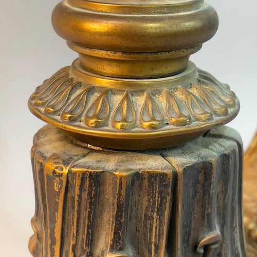 280 - A gilt metal baluster table lamp, on an inverted leaf base with flower head rounders, 54cm high to f... 