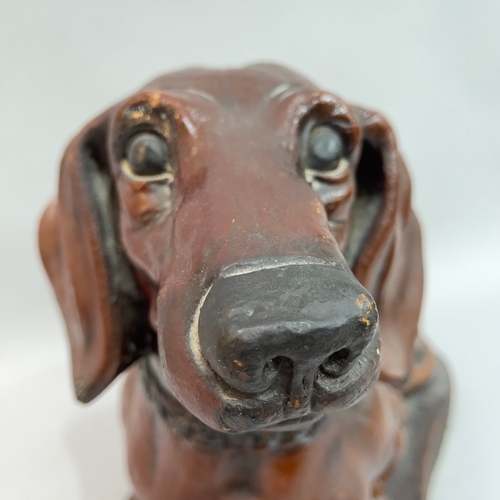 290 - A large resin Dachshund with collar on a base, 38cm high