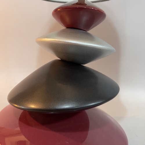 325 - A ceramic pebble tower table lamp in burgundy, black and pewter, with pewter-coloured drum shade, ov... 