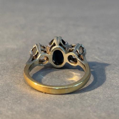 388 - A three stone ring circa 1950 in 18ct. yellow gold and platinum set with an oval facetted sapphire a... 