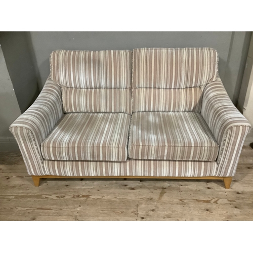 431 - A Parker Knoll beige and brown striped three piece suite comprising two seater sofa and two armchair... 