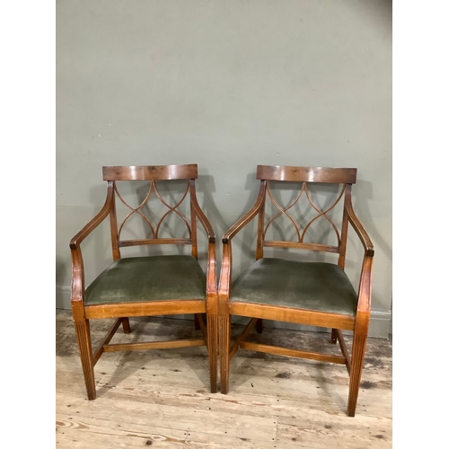 433 - A pair of walnut reproduction Regency style fluted carver chairs upholstered in green fabric