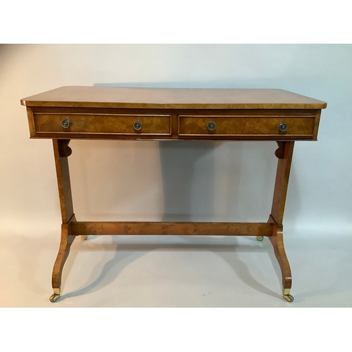 434 - A reproduction burr elm library table having two drawers to the apron, on twin refectory supports an... 