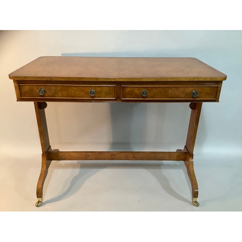 434 - A reproduction burr elm library table having two drawers to the apron, on twin refectory supports an... 