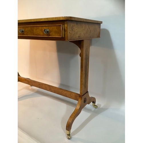 434 - A reproduction burr elm library table having two drawers to the apron, on twin refectory supports an... 