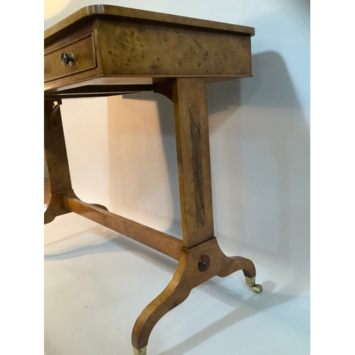 434 - A reproduction burr elm library table having two drawers to the apron, on twin refectory supports an... 