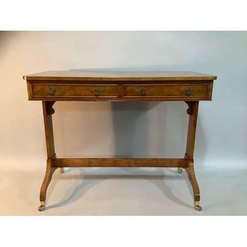 434 - A reproduction burr elm library table having two drawers to the apron, on twin refectory supports an... 