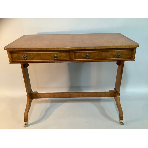 434 - A reproduction burr elm library table having two drawers to the apron, on twin refectory supports an... 