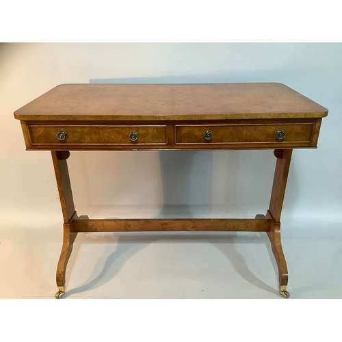 434 - A reproduction burr elm library table having two drawers to the apron, on twin refectory supports an... 