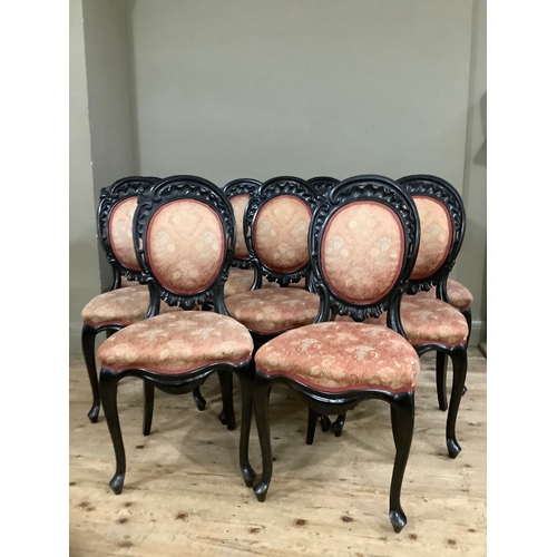 438 - A set of nine 19th century ebonised dining chairs having carved and pierced rocaille cresting above ... 