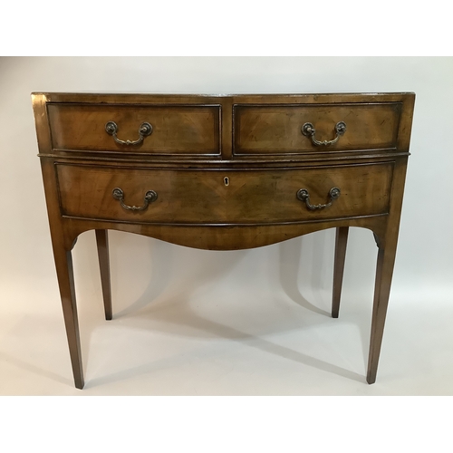 440 - A 1920s mahogany bow fronted side table having two short above one long drawer, on tapered legs, 84c... 