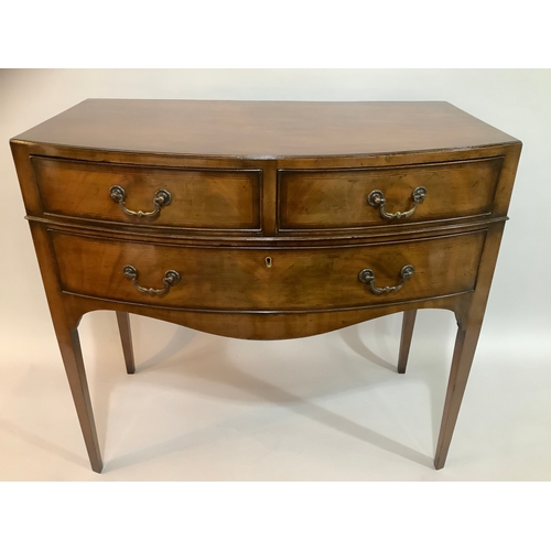 440 - A 1920s mahogany bow fronted side table having two short above one long drawer, on tapered legs, 84c... 