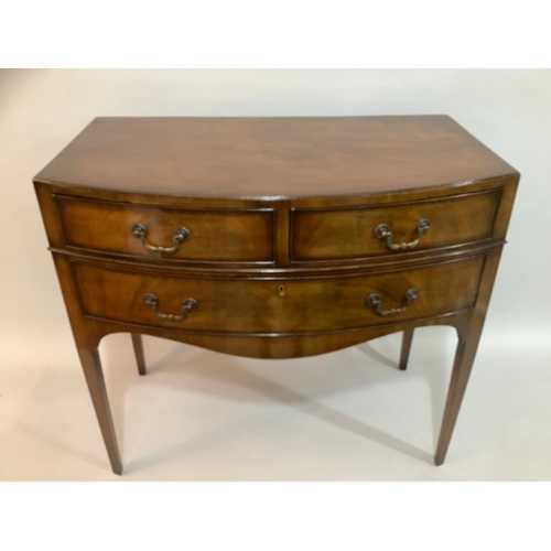 440 - A 1920s mahogany bow fronted side table having two short above one long drawer, on tapered legs, 84c... 