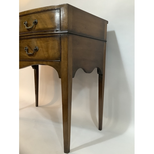 440 - A 1920s mahogany bow fronted side table having two short above one long drawer, on tapered legs, 84c... 