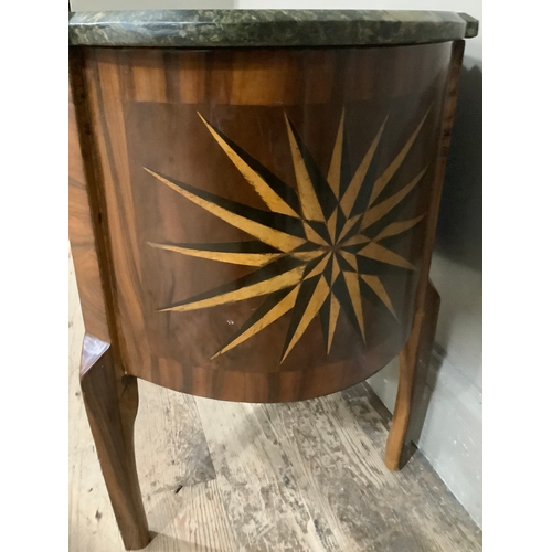 444 - A continental walnut starburst inlaid oval chest with two drawers above cut out apron and with marbl... 