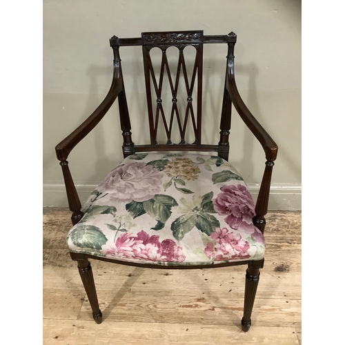 451 - An Edward VII mahogany open armchair with trellis panel to the back, the seat upholstered in floral ... 