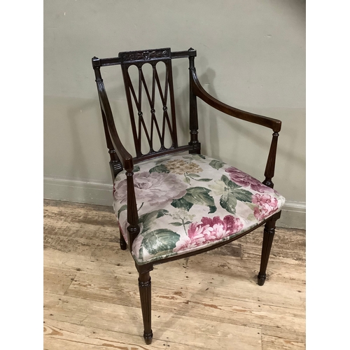 451 - An Edward VII mahogany open armchair with trellis panel to the back, the seat upholstered in floral ... 