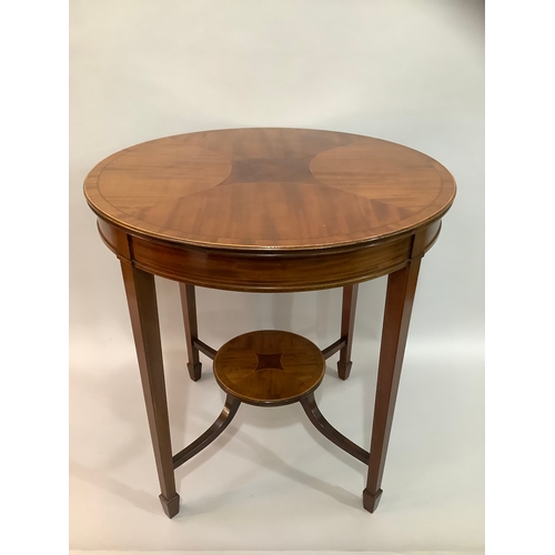 452 - An Edward VII mahogany cross banded occasional table of circular outline,  on four tapered legs join... 