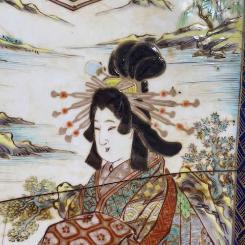 74 - A large 19th century Japanese charger, the interior enamelled with a geisha standing on a backgammon... 