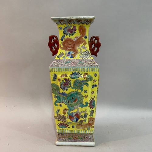 77 - A Chinese square vase enamelled with Chinese guardian lions with pearls and chrysanthemums, bordered... 