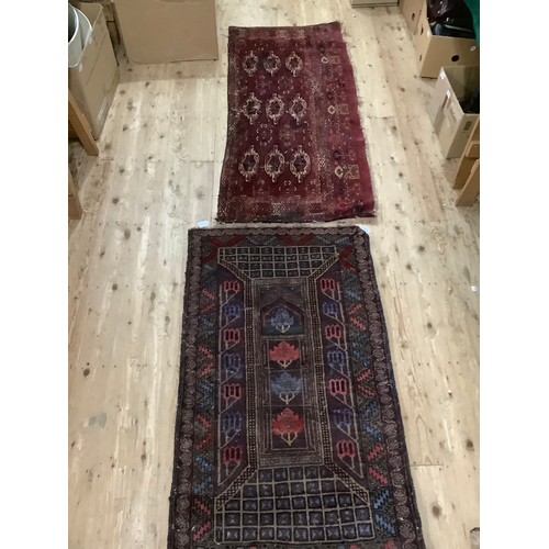 460 - A Middle Eastern flat weave rug having medallions on a wine field 149cm x 68cm and a wool rug with b... 