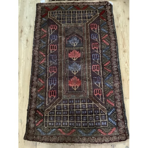 460 - A Middle Eastern flat weave rug having medallions on a wine field 149cm x 68cm and a wool rug with b... 